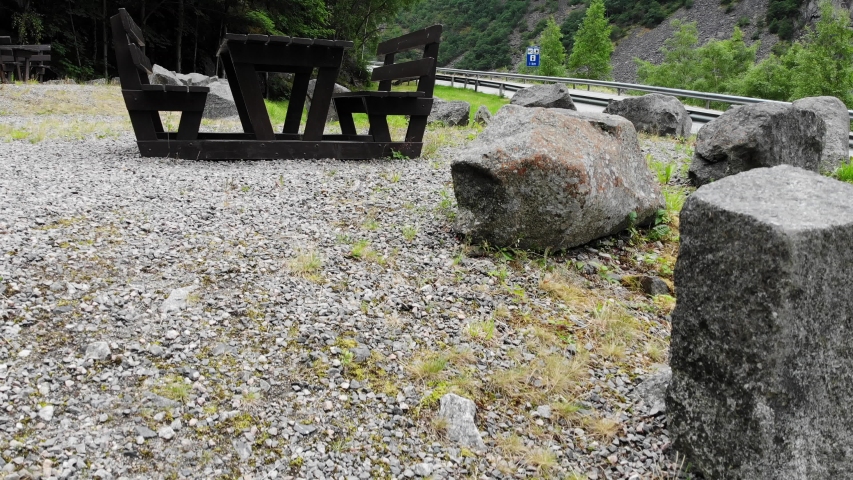 Aerial view. Picnic area wooden table with benches at road in summertime. Norwegian national tourist scenic route Hardangervidda