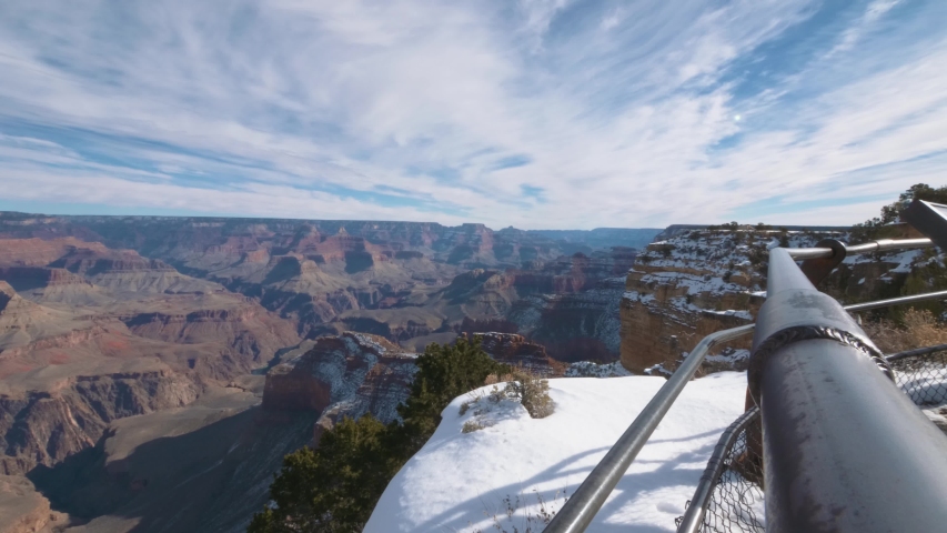 4K (UHD) Grand Canyon South Rim overlook during winter. Amazing landscapes with snow and clear skies. National Park, Arizona, United States of America.