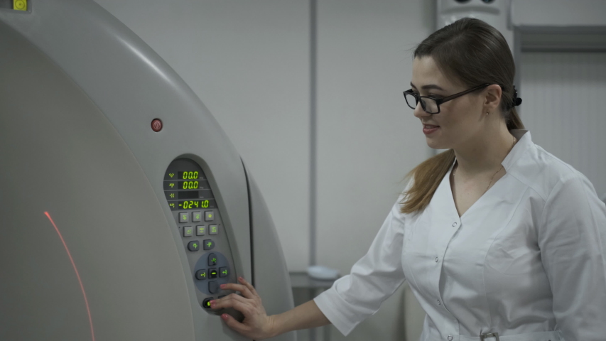Female Patient On The Ct Or Mri Scanner Machine During X-Ray Process,