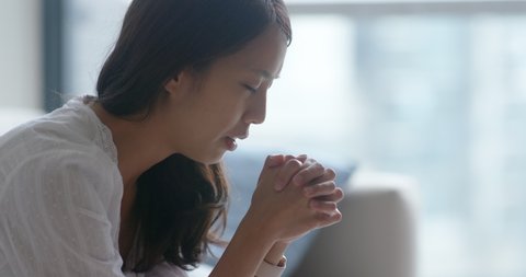 Woman pray to the god at home