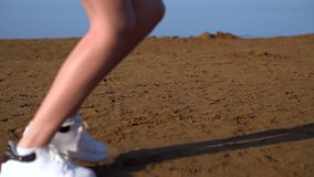 Young woman jogging along a sandy beach
