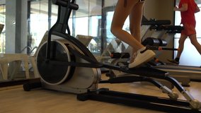 Close up of young woman using running machine
