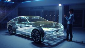 Automotive Engineer Working on Electric Car Chassis Platform, Using Tablet Computer with Augmented Reality 3D Software. Innovative Facility: Vehicle Frame with Wheels Becomes a Solid Virtual Model. - Powered by Shutterstock - Get 15% off with code: PIKWIZARD15