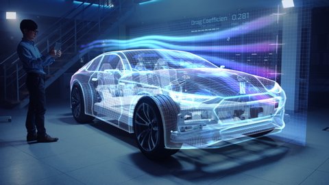 Automotive Engineer Working on Electric Car Chassis Platform, Using Tablet Computer with Augmented Reality 3D Software. Innovative Facility: Vehicle Virtual Mesh Model is Tested for Aerodynamics.