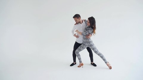 Concept of love, relationships and social dancing. Social dance, salsa, zouk, tango, kizomba concept - beautiful couple dancing bachata