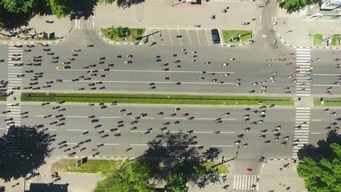 aerial top down shot of city road crowded by cyclists during bycicle competition