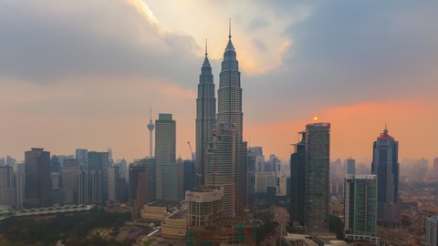 KUALA LUMPUR, MALAYSIA - APRIL 2016: Time lapse of high angle view near The Petronas Towers at sunset of April 20, 2016 in Kuala Lumpur, Malaysia. Zoom out motion timelapse.