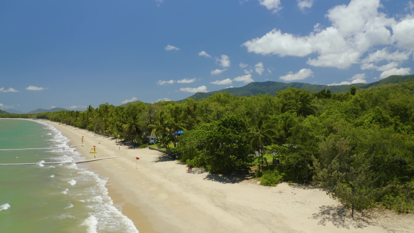 Aerial, beautiful view on tropical vegetation and hills on australian coast and Clifton Beach in Cairns, Queensland