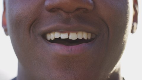 Close up of man's mouth talking directly to camera 