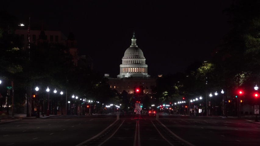A nearly empty Pennsylvania Avenue in the middle of the night showing the national capital of the United States in Washington, DC.