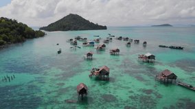 4k video footage from drone of stilt houses and boats in Sulawesi sea