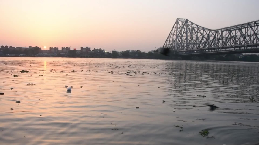 Water flow in Ganges river near Howrah bridge ( Kolkata city ) at sunset time, full HD 