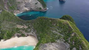 Aerial drone video of beautiful exotic beach with green rocks, Kelingking beach, Nusa Penida, Bali, Indonesia, 4K 