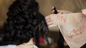 Closeup of professional hairdresser hands doing beauty hairstyle. Increase hair.