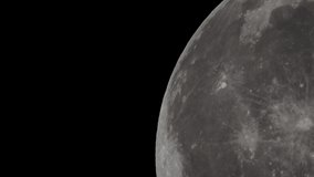 a super telephoto video of The giant full Moon passing through the night sky in space taken with a telescope