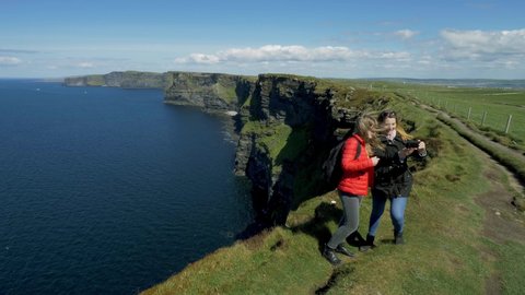 Two girls at the famous Cliffs of Moher in Ireland