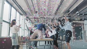 Manager start to dance on the table, sings into a megaphone, accelerates and slide on lap. Colleagues blow up flappers with confetti. Employees celebrate success. Corporate party business team - Powered by Shutterstock - Get 15% off with code: PIKWIZARD15