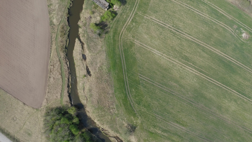 Bird's eye view following a river, then a bridge leading to nowhere