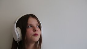 Teen girl is singing and listen to music on headphones