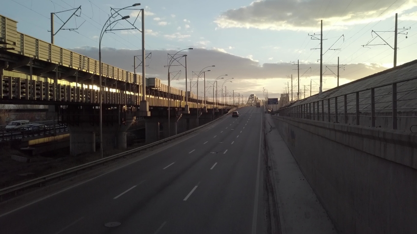 Aerial view on traffic bridge over river in sunny day, cars on bridge