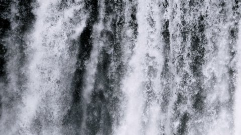 Skógafoss Waterfall close-up view slow motion texture making by water
