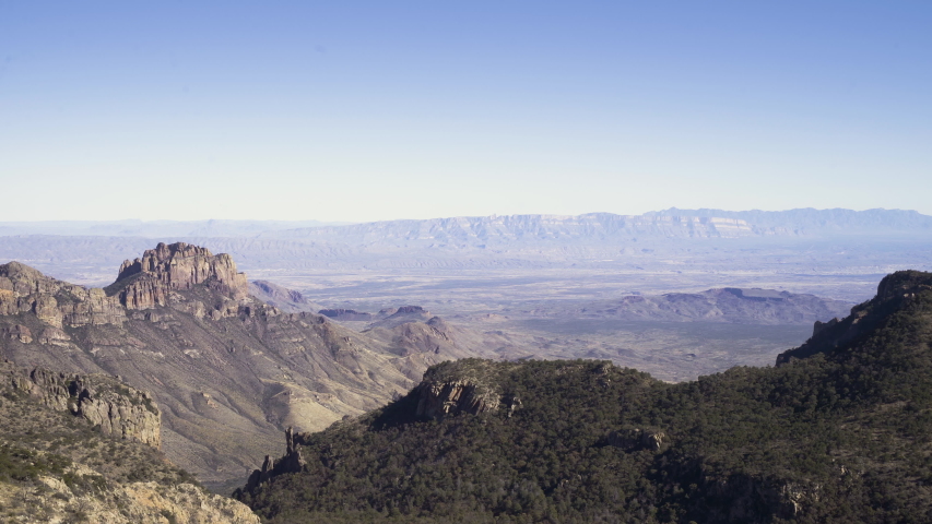 Panning to left, wide establishing shot over the Rocky mountains, mountain chain
