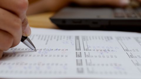Closeup shot of a chartered accountant checking company balance sheet.