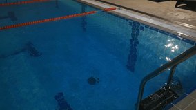 Slow motion of male swimmer doing flip turn in swimming pool, Full HD shot - Powered by Shutterstock - Get 15% off with code: PIKWIZARD15