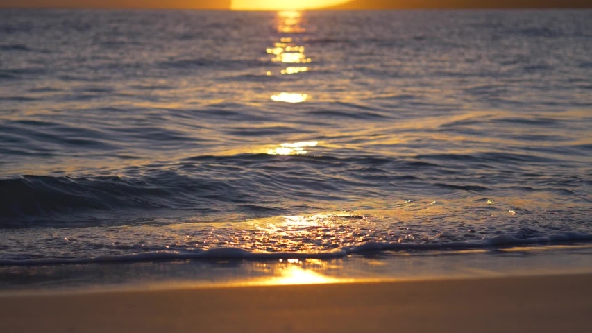 Sunrise over Australian beach and waves (slow motion)