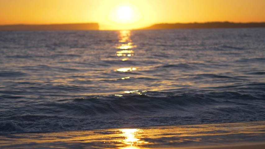 Sunrise over Australian beach and waves (slow motion)