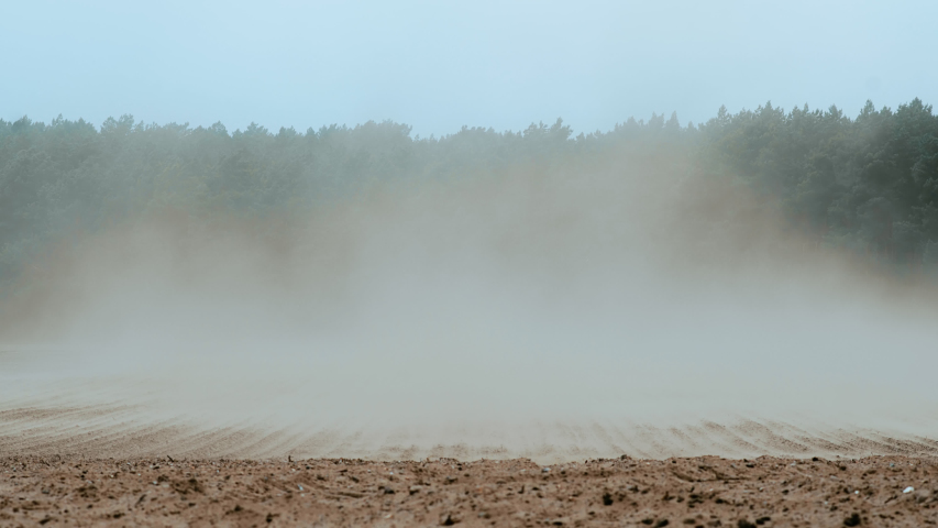 Dust clouds created by strong winds sweeping soil off a field, altering the increase of erosion rates due to unsustainable agricultural practices in Germany. | Shutterstock HD Video #1030032734