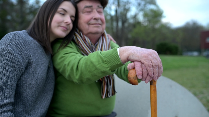 Senior enjoying time with his granddaughter during a walk