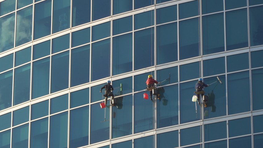 window washers on skyscrapers work Stock Footage Video (100% Royalty