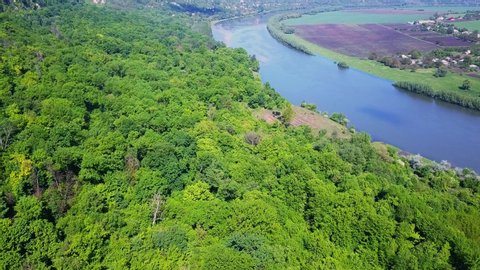 Flight over the river and forest at spring time. Dniester river of Moldova republic.