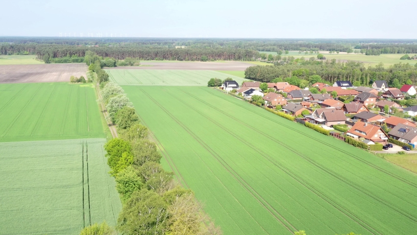 aerial view, pan, drone camera, border, village, over, green, farmland, field, wheat, drone, camera, suburb, house, houses, roof, roofs, single family house, semi-detached house, terraced house, real 