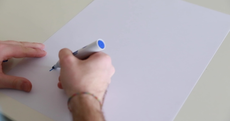shooting of how a person draws on paper with a marker, Italy