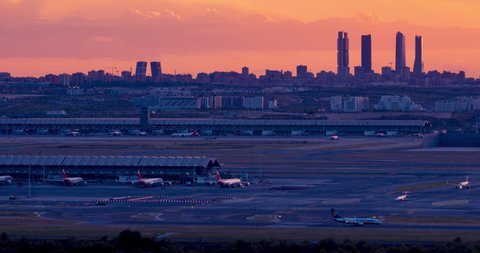 Sunset seen from Paracuellos del Jarama. Timelapse of Madrid skyline with beautiful sunset and impressive storm clouds. Madrid airport and 4 towers bussines area as main subject.