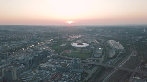 Aerial drone shot of the huge Mercedes Benz Arena in Stuttgart, Baden Wuerttemberg while sunset. Home of the football club VFB Stuttgart