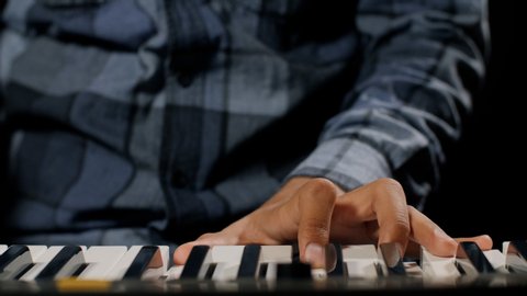 Pianist plays on the electronic piano at the recording studio.