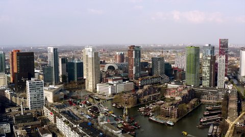 The skyline of Rotterdam, Netherlands. Aerial flight where the drone slowlyes into the cityscape on a sunny afternoon.