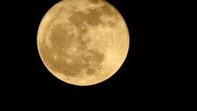 4K video Full Moon Bright Illuminated. Night moon moving in the dark sky.