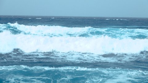 Large blue ocean waves crashing on sunny day. Powerful ocean wave  