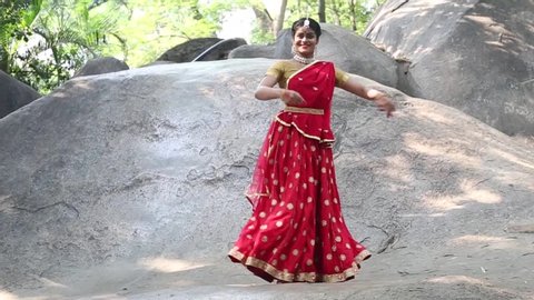 Indian Classical kathak dancers in traditional wear performing outdoors.