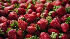 Background top view 4k video of strawberries rotating