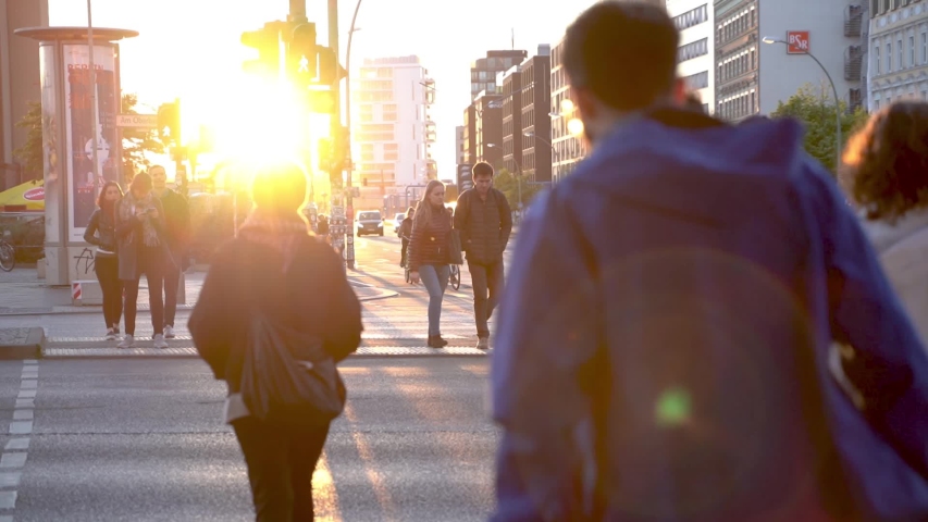 Berlin, Germany - 13 May 2019. People crossing the street at sunset