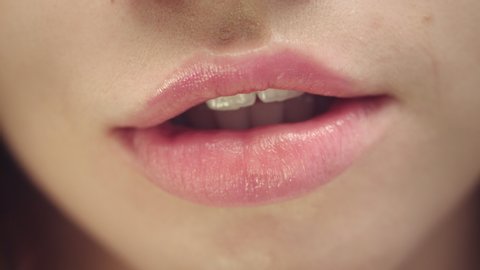 Female face of attractive woman with opened mouth. Close up attractive woman face opening sensual mouth. Sexy and plump female lips. Lips care and makeup