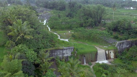 Cinematic aerial footage drone flying slow sideway down motion view of waterfall cascade dam