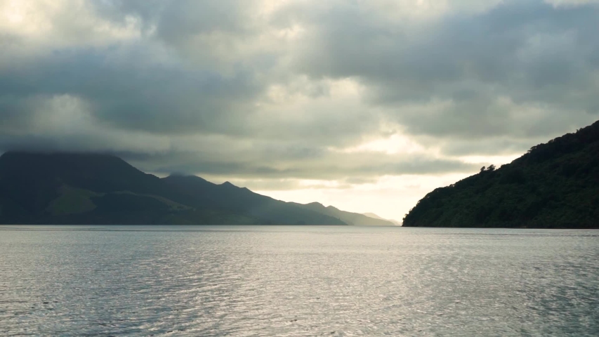 Beautiful view from boat of ocean, hills and clouds in Marlborough Sounds, New Zealand