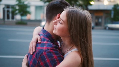 I missed you so much. Affectionate and sincere couple embrace. Love expression. Young man and woman hug in the street
