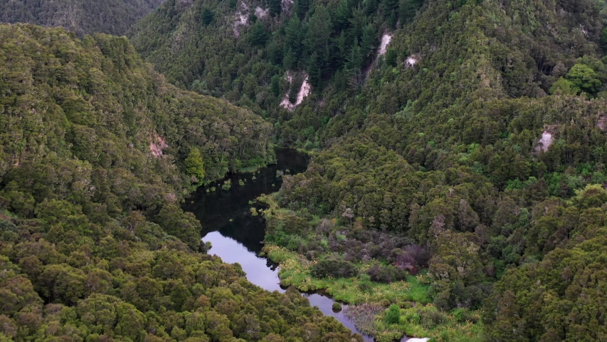 Aerial view of a solo kayaker starting to move in a New Zeland river